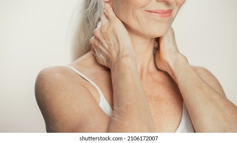 Anonymous Senior Woman Touching Her Neck, Chest, With Sensual Movement Of Hands, Enjoying Soft Skin. Elderly Female Natural Beauty. Dignity And Grace In Old Age. Concept For Skin Care, Healthy Living