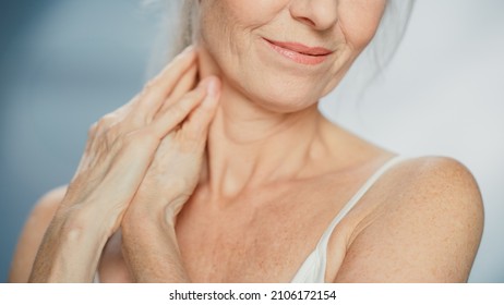 Anonymous Senior Woman Touching Her Neck, Chest, With Hands, Enjoying Soft Skin. Elderly Female Natural Beauty. Dignity And Grace In Old Age. Isolated Background For Skin Care, Healthy Living Concept