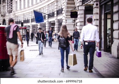 Anonymous Shoppers Walking Down Busy London Shopping Street