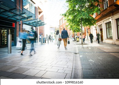 Anonymous shoppers walking on a shopping high street