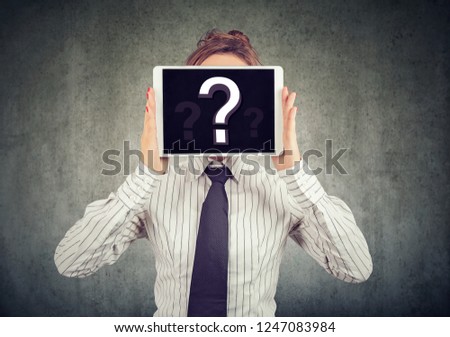 Anonymous woman covering face with tablet showing question mark hiding personality in Internet