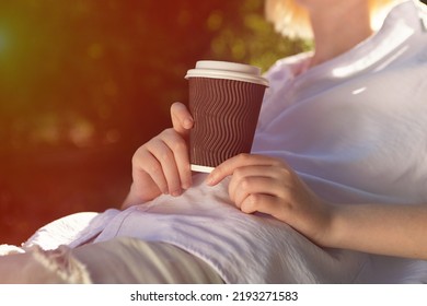 Anonymous Woman Holding Craft Paper Cup With Coffee Outside,sunlight On Background.