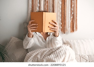 Anonymous Woman Reading Book On Bed