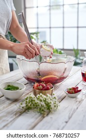 Anonymous Woman Serves Sangria From Punch Bowl Into Glasses For Summer Party Independence Day Celebration