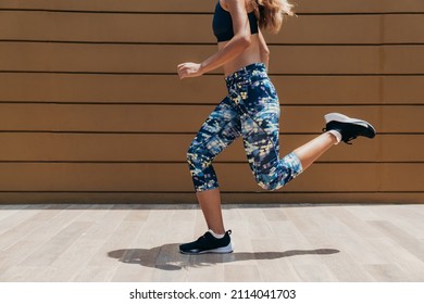 An Anonymous Woman In Sportswear Running Outdoors