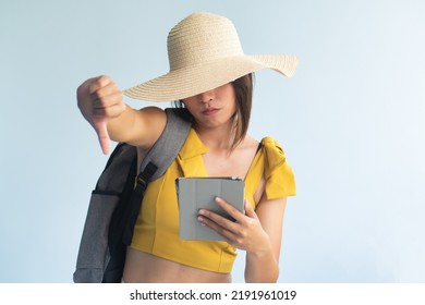 Anonymous Woman Traveler Using Tablet Computer Giving Frustrating Thumb Down, Concept Image For Slow Or Expensive Internet Connection, Pay To Win Game App, Bad Electronica Transaction Deal