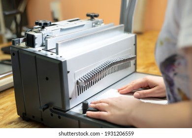 Anonymous Woman Working On Book Binding Machine