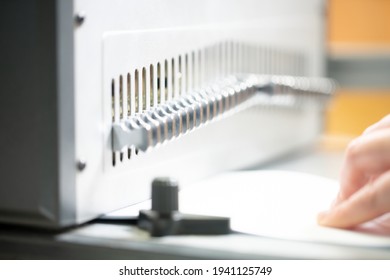 Anonymous Woman Working On Book Binding Machine