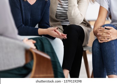 Anonymous women sitting in circle during group meeting