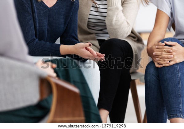 Anonymous\
women sitting in circle during group\
meeting