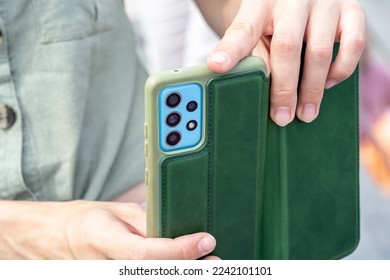 Anonymous young girl taking vertical photos recording videos for social media, using her smartphone holding it in hands, mobile phone photography, multiple cameras concept, one person, detail, closeup