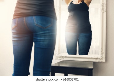 Anorexia Concept - Woman Looks At Her Fat Reflection In Mirror