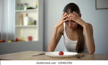 Anorexic girl feels dizzy, depleted by severe diets, exhausted body, starvation - Shutterstock ID 1294813783