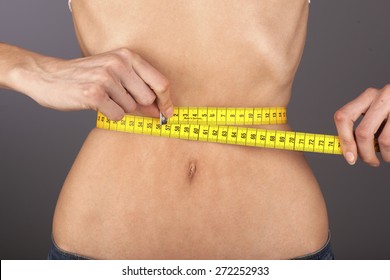 Anorexic woman, tape-measure