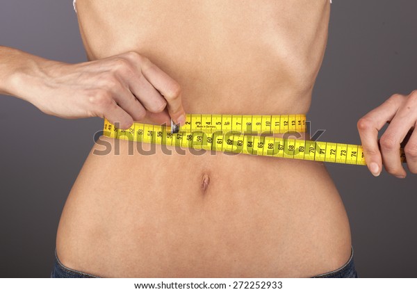 Anorexic woman,\
tape-measure