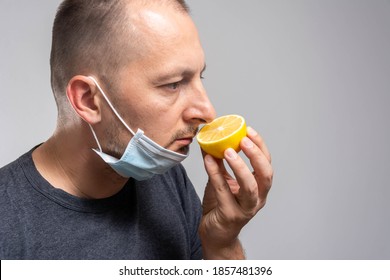 Anosmia or smell blindness, loss of the ability to smell, one of the possible symptoms of covid-19, infectious disease caused by corona virus. Man Trying to Sense Smell of a Lemon - Shutterstock ID 1857481396