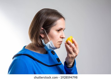 Anosmia or smell blindness, loss of the ability to smell, one of the possible symptoms of covid-19, infectious disease caused by corona virus. Man Trying to Sense Smell of a Lemon, side view.