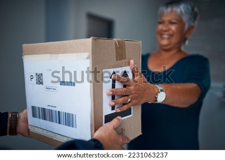 Another package delivered on time, how great. Cropped shot of a package being delivered to a senior woman.