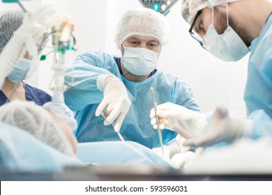 Another surgery. Surgery medical team operating in a surgery room of the hospital mature surgeon leading an operation profession professionalism occupation teamwork medical people doctors concept - Shutterstock ID 593596031