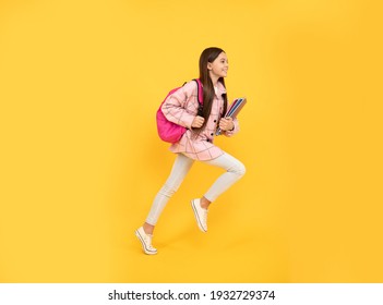 another year grasps. energetic student hold notebooks running. hurry up. back to school. teen girl jump in checkered shirt. happy kid run with backpack. tween child carry bag. childhood education. - Shutterstock ID 1932729374