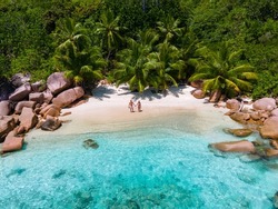 Anse Lazio Praslin Seychelles, A Young Couple Of Men And Women On A Tropical Beach During A Luxury Vacation In Seychelles. Tropical Beach Anse Lazio Praslin Seychelles
