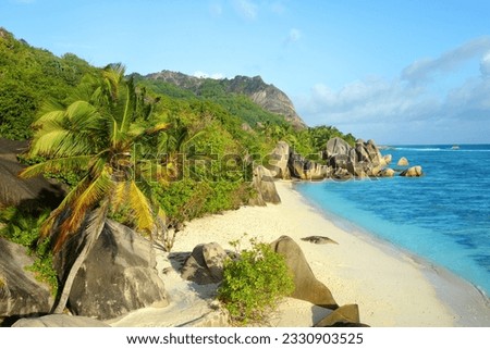 Anse Source d'Argent beach with big granite rocks in sunny day. La Digue Island, Indian Ocean, Seychelles. Tropical destination.