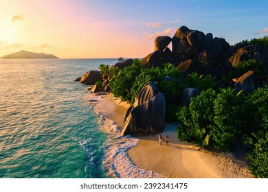 Anse Source d'Argent beach, La Digue Island, Seychelles, Drone aerial view of La Digue Seychelles bird eye view. of tropical Island, couple men and woman walking at the beach at a luxury vacation