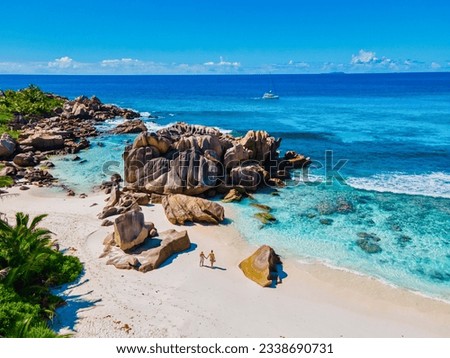 Anse Source d'Argent beach, La Digue Island, Seyshelles, Drone aerial view of La Digue Seychelles bird eye view.of tropical Island. mature couple men and women on vacation Seychelles