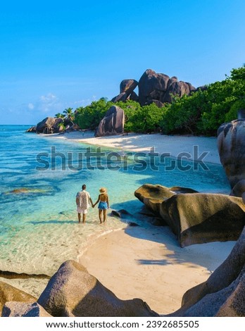 Anse Source d'Argent beach, La Digue Island, Seychelles, couple men and woman relaxing at the beach at a luxury vacation in the Seychelles La Digue Island