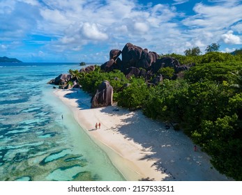 Anse Source d'Argent, La Digue Seychelles, a young couple of men and women on a tropical beach during a luxury vacation in Seychelles. Tropical beach Anse Source d'Argent, La Digue Seychelles - Shutterstock ID 2157533511