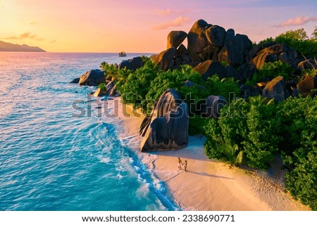 Anse Source d'Argent, La Digue Seychelles, a young couple of men and women on a tropical beach during a luxury vacation in Seychelles. Tropical beach Anse Source d'Argent, La Digue Seychelles