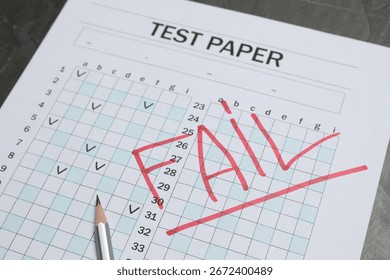Answer sheet with word Fail and pencil on gray table, closeup. Student passing exam