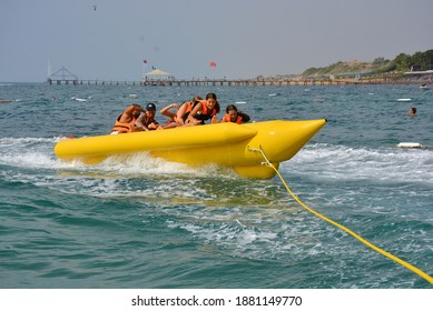 Antalya Turkey 09.10.2020: The Children Enjoying On Banan Boat And Falling On Holiday. 