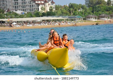 Antalya Turkey 09.10.2020: The Children Enjoying On Banan Boat And Falling On Holiday. 