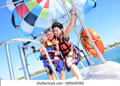 Antalya Turkey 15.10.2020: Mother and son flying with parasailing on holiday after corona time.