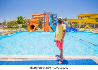 Antalya, Turkey - August 7, 2020: Compliance With Quarantine On The Beaches Of Turkish. Hotel Worker In A Medical Mask And Gloves During Quarantine COVID-19. Hotels Are Ready To Meet Tourists