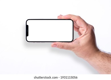 Antalya, Turkey - March 07, 2021: Hand Holding Black Smartphone IPhone 12 With White Screen. Isolated On White Background. Mobile Phone Frameless Design Concept.
