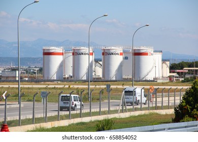 Antalya, Turkey - May 23 2017: Tank oil storage company LUKOIL with gasoline near the city airport in the background of the road with cars, spring-summer, Sunny weather