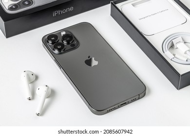 Antalya, Turkey - November 30, 2021: Back view of new iPhone 13 Pro smartphone and Apple Airpods 2 earphone.