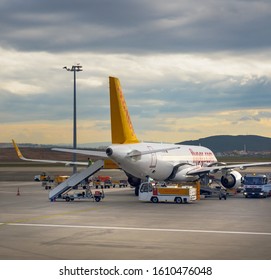 ANTALYA, TURKEY - November 5, 2019: The passenger aircraft near the terminal in an Antalya international airport at sunset. Aircraft of the Turkish airlines of Pegasus on prepare of depart service.