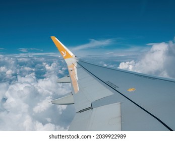 Antalya, Turkey - September 12, 2021: The logo of Pegasus airlines on the wing of the plane flying over the finds.