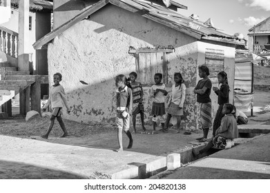 ANTANANARIVO, MADAGASCAR - JULY 1, 2011: Unidentified Madagascar children in the street near the house. People in Madagascar suffer of poverty due to slow development of the country