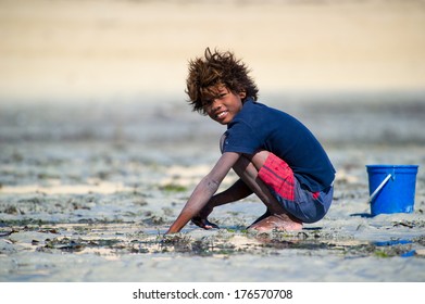 ANTANANARIVO, MADAGASCAR - JULY 3, 2011: Unidentified Madagascar boy plays with sand. People in Madagascar suffer of poverty due to slow development of the country
