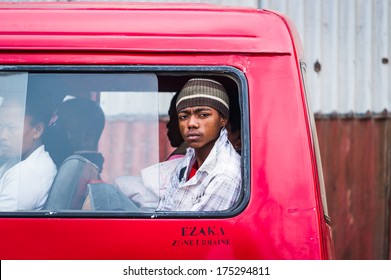 ANTANANARIVO, MADAGASCAR - JUNE 28, 2011: Unidentified Madagascar serious man looks out of a minivan window. People in Madagascar suffer of poverty due to the slow development of the country