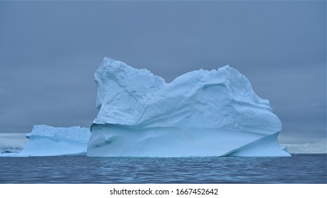 Antarctic Peninsula, Antarctica - January 2020: Massive Chunks Of Ice Melting Off Ice Shelves Creating Gigantic Icebergs 