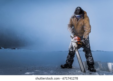 Antarctic Worker Cutting Sea Ice With Chainsaw