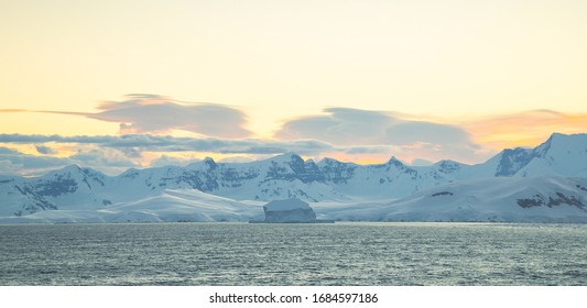 Antarctica Peninsula Landscape With People, Ships, Tender Boats, Penguins, Icebergs And Mountains