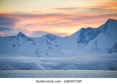 Antarctica Peninsula Landscape With People, Ships, Tender Boats, Penguins, Icebergs And Mountains