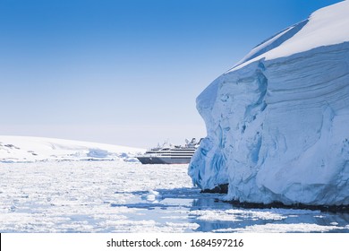 Antarctica Peninsula Landscape With People, Ships, Tender Boats, Penguins, Icebergs And Mountains