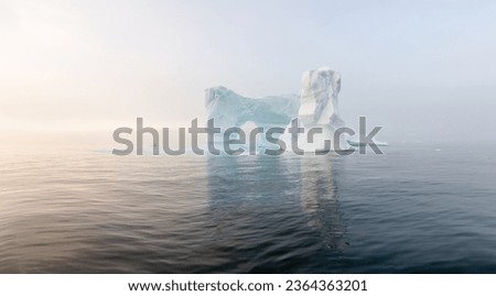 Antarctica, South Georgia Island. A lonely glacier. Blue glaciers in the ocean water. Glacial drift on calm water. Clean chunks of ice from a melting glacier. Global warming concept climate change.
